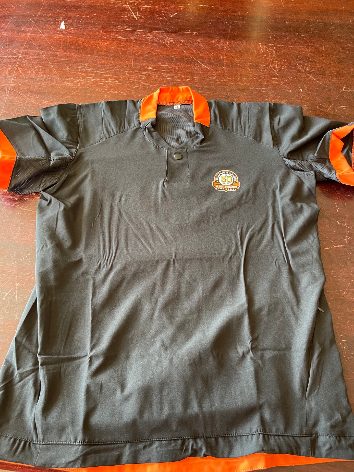 Black and Orange Cage Shirt with WLL 50 year Logo